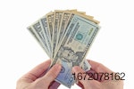 US-dollars-fanned-in-hand-.jpg
