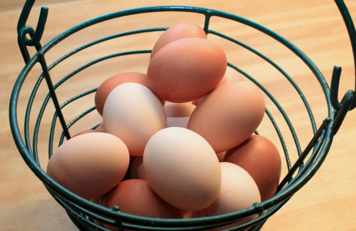 Brown and white eggs in a basket