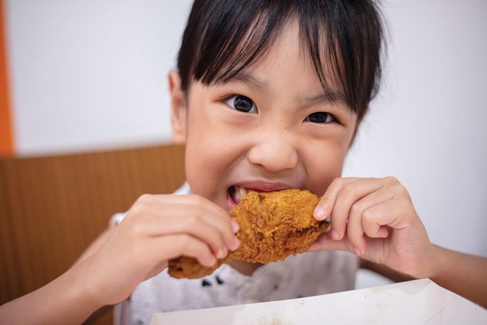 asian-little-girl-eating-fried-chicken.jpg