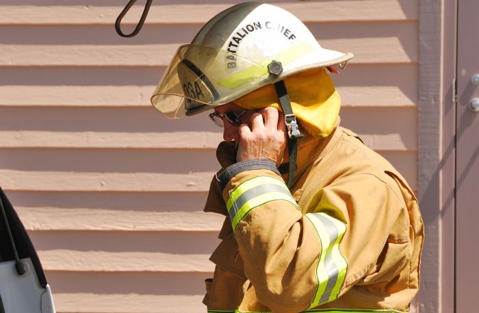 Firefighter-putting-mask-on