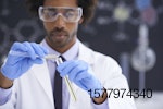man in lab mixing test tubes